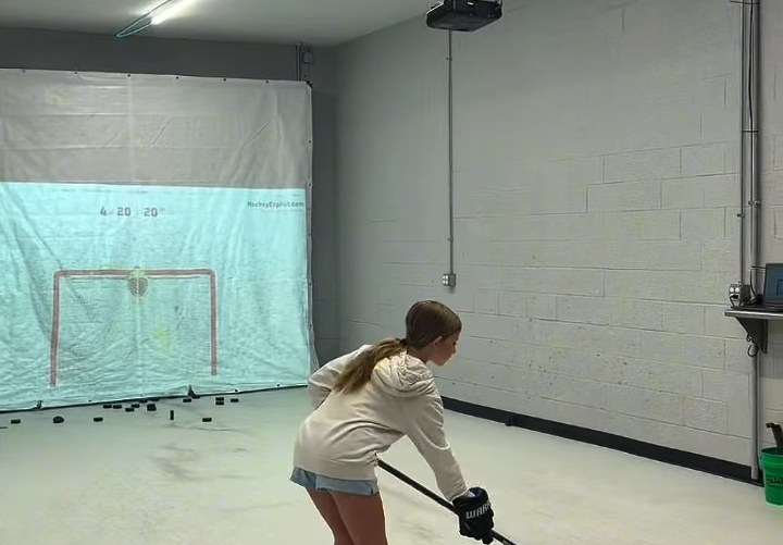 Player shooting at the projected-target simulator