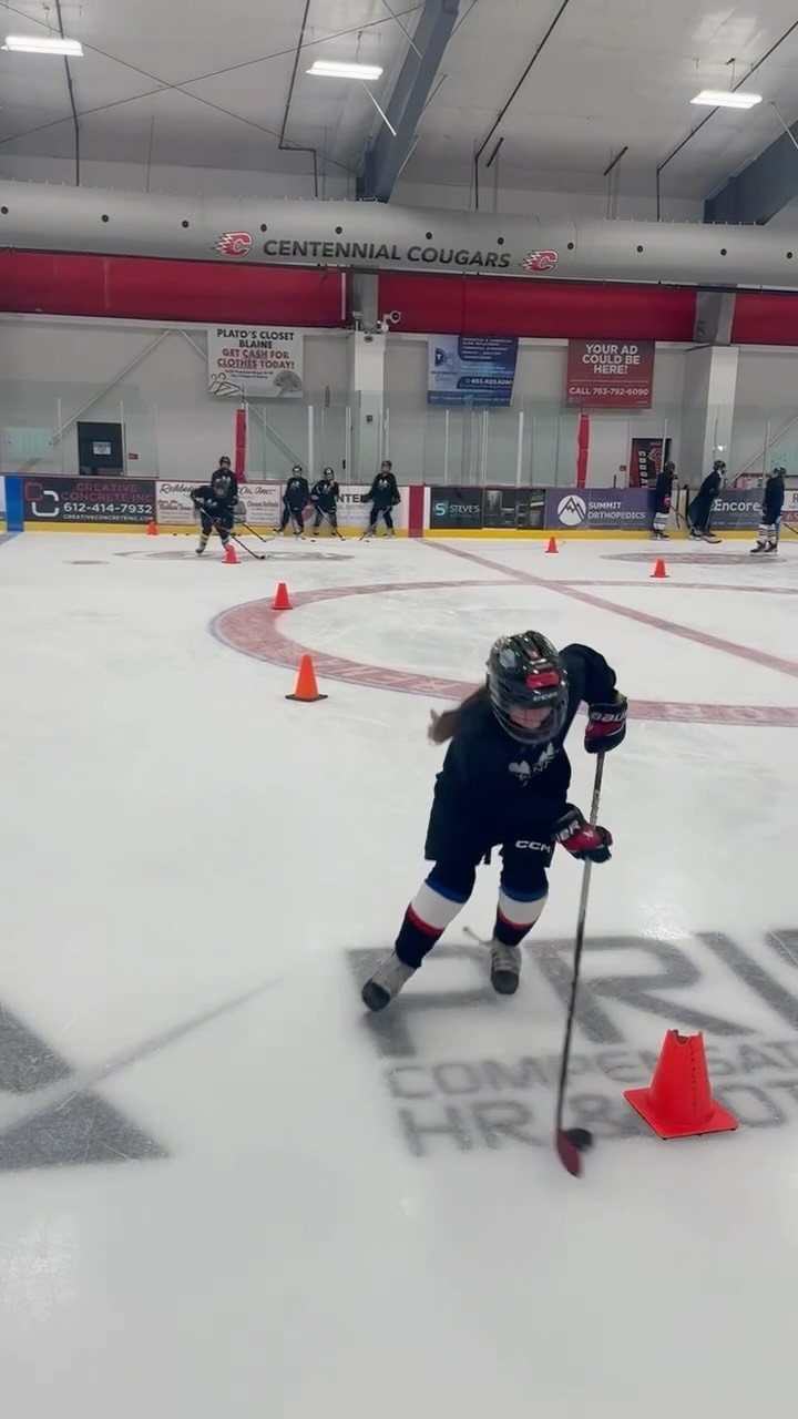 Player skating through cones at the Centennial rink